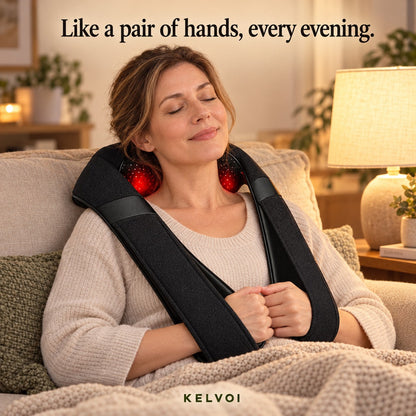 Woman relaxing on a couch in the evening wearing the KneadWrap massager